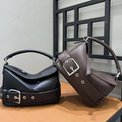 Two leather shoulder bags on a table