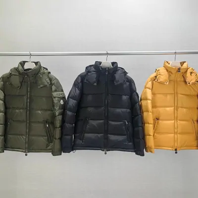 Three down jackets on a rail